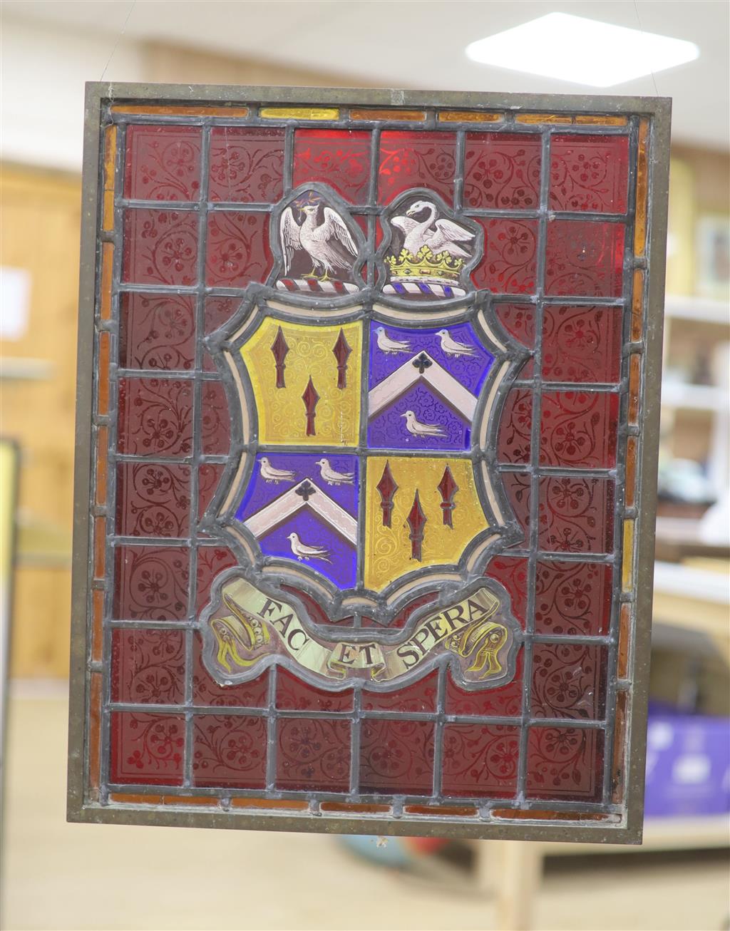 An armorial stained glass panel, in a brass frame, 44.5 x 35cm